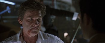 Movie still from “Poseidon” (2006), directed by Wolfgang Petersen – A person wearing a white shirt; Close Up shot, Low angle