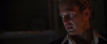 Movie still from “Poseidon” (2006), directed by Wolfgang Petersen – A person wearing a shirt and tie; Close Up shot, Low angle
