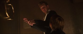 Movie still from “Poseidon” (2006), directed by Wolfgang Petersen – A man in a black suit and a woman in a white shirt; Medium shot, Over the shoulder angle