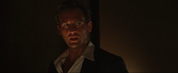 Movie still from “Poseidon” (2006), directed by Wolfgang Petersen – A person wearing a suit and tie; Close Up shot, Low angle