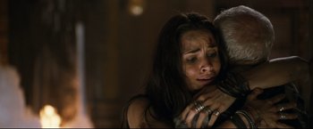 Movie still from “Poseidon” (2006), directed by Wolfgang Petersen – A woman is crying while holding a man; Close Up shot, Overhead angle