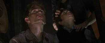Movie still from “Poseidon” (2006), directed by Wolfgang Petersen – Two young men looking up at the ceiling; Close Up shot, Low angle
