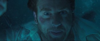 Movie still from “Poseidon” (2006), directed by Wolfgang Petersen – A person's face in the water; Close Up shot, Overhead angle