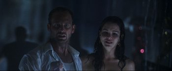 Movie still from “Poseidon” (2006), directed by Wolfgang Petersen – A man and a woman standing next to each other in the dark; Close Up shot, Low angle