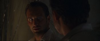 Movie still from “Poseidon” (2006), directed by Wolfgang Petersen – A man looking at his reflection in a mirror; Close Up shot, Over the shoulder angle