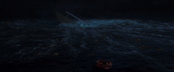 Movie still from “Poseidon” (2006), directed by Wolfgang Petersen – A small boat in the middle of the ocean at night; Extreme Wide shot, High angle