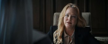 Movie still from “Prey for the Devil” (2022), directed by Daniel Stamm – A woman sitting at a desk in a chair looking at the camera; Close Up shot, Over the shoulder angle