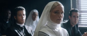 Movie still from “Prey for the Devil” (2022), directed by Daniel Stamm – Two women dressed as nuns are standing in a dark room; Close Up shot, Low angle