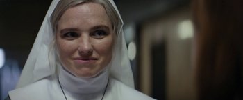 Movie still from “Prey for the Devil” (2022), directed by Daniel Stamm – A woman wearing a nun's outfit and a veil; Close Up shot, Low angle