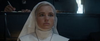 Movie still from “Prey for the Devil” (2022), directed by Daniel Stamm – A woman in a nun's outfit looking into the camera; Close Up shot, Low angle