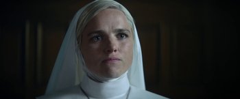 Movie still from “Prey for the Devil” (2022), directed by Daniel Stamm – A woman wearing a nun's head covering; Close Up shot, Low angle