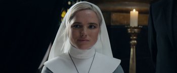 Movie still from “Prey for the Devil” (2022), directed by Daniel Stamm – A woman wearing a nun's outfit and a necklace; Close Up shot, Low angle
