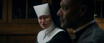 Movie still from “Prey for the Devil” (2022), directed by Daniel Stamm – A woman in a nun's outfit and a man in a priest's outfit; Close Up shot, Over the shoulder angle