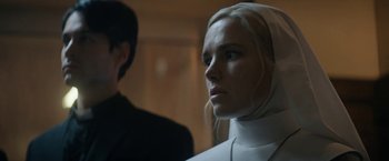 Movie still from “Prey for the Devil” (2022), directed by Daniel Stamm – A woman wearing a nun's outfit looking at the camera; Close Up shot, Low angle