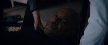 Movie still from “Prey for the Devil” (2022), directed by Daniel Stamm – A person laying on the ground; Close Up shot, High angle