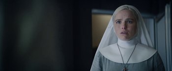 Movie still from “Prey for the Devil” (2022), directed by Daniel Stamm – A woman in a nun's outfit standing in front of a mirror; Close Up shot, Low angle