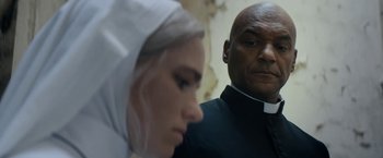 Movie still from “Prey for the Devil” (2022), directed by Daniel Stamm – A man and a woman are looking at each other; Close Up shot, Low angle