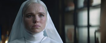 Movie still from “Prey for the Devil” (2022), directed by Daniel Stamm – A woman wearing a nun's veil looking at the camera; Close Up shot, Low angle