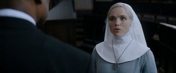 Movie still from “Prey for the Devil” (2022), directed by Daniel Stamm – A woman in a nun's outfit looking at the camera; Close Up shot, Over the shoulder angle