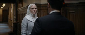 Movie still from “Prey for the Devil” (2022), directed by Daniel Stamm – A woman wearing a nun's veil looking at a man in a suit; Close Up shot, Over the shoulder angle