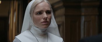 Movie still from “Prey for the Devil” (2022), directed by Daniel Stamm – A woman in a nun's outfit looking into the distance; Close Up shot, Low angle