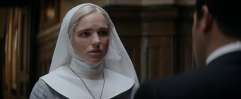 Movie still from “Prey for the Devil” (2022), directed by Daniel Stamm – A woman in a nun's outfit looking into the distance; Close Up shot, Over the shoulder angle
