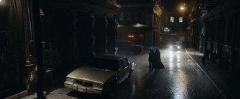 Movie still from “Prey for the Devil” (2022), directed by Daniel Stamm – Two people walking down the street with an umbrella; Extreme Wide shot, High angle