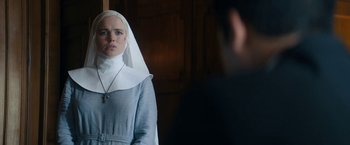 Movie still from “Prey for the Devil” (2022), directed by Daniel Stamm – A woman in a nun's outfit looking at a man in a suit; Close Up shot, Over the shoulder angle