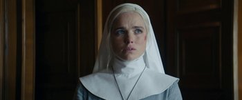 Movie still from “Prey for the Devil” (2022), directed by Daniel Stamm – A woman in a nun's outfit looking at the camera; Close Up shot, Low angle