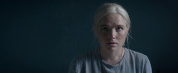 Movie still from “Prey for the Devil” (2022), directed by Daniel Stamm – A woman with blonde hair is looking at the camera; Close Up shot, Over the shoulder angle