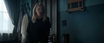 Movie still from “Prey for the Devil” (2022), directed by Daniel Stamm – A woman standing in front of a door; Medium shot, Over the shoulder angle