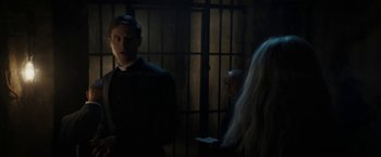 Movie still from “Prey for the Devil” (2022), directed by Daniel Stamm – A man standing next to another man in a jail cell; Medium shot, Over the shoulder angle