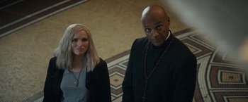 Movie still from “Prey for the Devil” (2022), directed by Daniel Stamm – A man and a woman standing next to each other; Medium shot, Over the shoulder angle