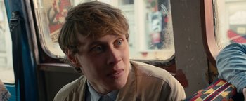 Movie still from “Pride” (2014), directed by Matthew Warchus – A young man sitting in the back seat of a car; Close Up shot, Over the shoulder angle