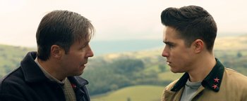 Movie still from “Pride” (2014), directed by Matthew Warchus – Two men face each other in a field; Close Up shot, Over the shoulder angle