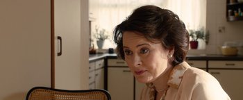 Movie still from “Pride” (2014), directed by Matthew Warchus – An older woman sitting at a table in a kitchen; Close Up shot, Over the shoulder angle