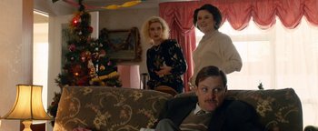 Movie still from “Pride” (2014), directed by Matthew Warchus – Three women and a man are sitting in a living room; Medium shot, Over the shoulder angle