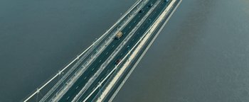 Movie still from “Pride” (2014), directed by Matthew Warchus – An aerial view of a bridge with cars driving on it; Extreme Wide shot, High angle