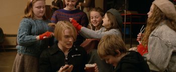 Movie still from “Pride” (2014), directed by Matthew Warchus – A group of people that are sitting in a room together; Medium shot, Over the shoulder angle