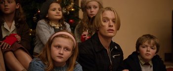 Movie still from “Pride” (2014), directed by Matthew Warchus – A group of people sitting in front of a christmas tree; Close Up shot, Low angle