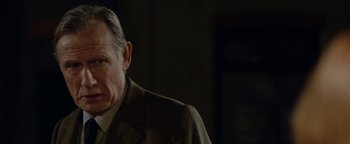 Movie still from “Pride” (2014), directed by Matthew Warchus – An older man wearing a suit and tie; Close Up shot, Over the shoulder angle