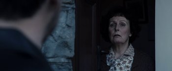 Movie still from “Pride” (2014), directed by Matthew Warchus – An older woman standing in front of a window; Close Up shot, Over the shoulder angle