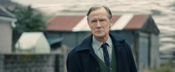Movie still from “Pride” (2014), directed by Matthew Warchus – An older man wearing a tie and a coat; Close Up shot, Over the shoulder angle