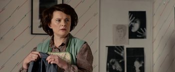 Movie still from “Pride” (2014), directed by Matthew Warchus – A woman holding onto a piece of fabric in a room; Medium shot, Over the shoulder angle