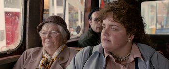 Movie still from “Pride” (2014), directed by Matthew Warchus – Two women and a man are sitting on a bus; Close Up shot, Over the shoulder angle