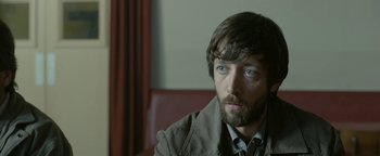 Movie still from “Pride” (2014), directed by Matthew Warchus – A person with a beard; Close Up shot, Over the shoulder angle