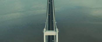 Movie still from “Pride” (2014), directed by Matthew Warchus – An aerial view of a bridge over a body of water; Extreme Wide shot, Overhead angle