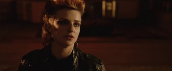 Movie still from “Pride” (2014), directed by Matthew Warchus – A woman with red hair wearing a leather jacket; Close Up shot, Over the shoulder angle
