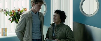 Movie still from “Pride” (2014), directed by Matthew Warchus – Two people standing next to each other in a room; Medium shot, Over the shoulder angle