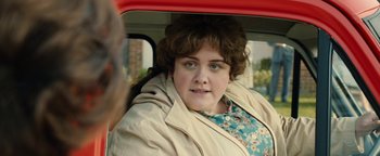 Movie still from “Pride” (2014), directed by Matthew Warchus – A woman sitting in the back seat of a car; Close Up shot, Over the shoulder angle